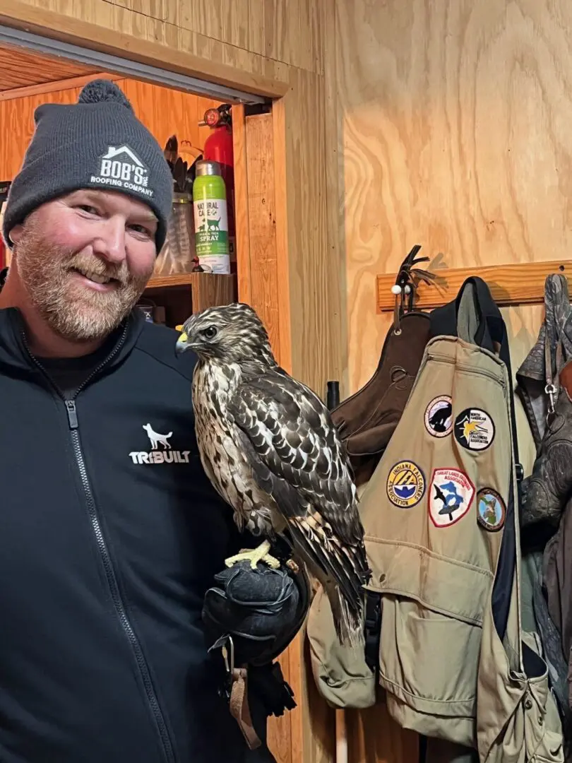 Ryan Garvelnk with red shouldered hawk